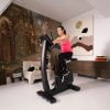 hometrainer B5s van Flow Fitness met 10,1 touchscreen met vrouw in actie