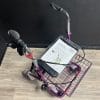 Premis Provo rollator paars, schuin-bovenaanzicht, met eenzijdige rem rechts en mand met handleiding onder het stuur.