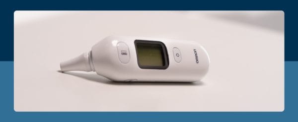 Witte OMRON Gentle Temp 533 infrarood oorthermometer liggend op licht oppervlak