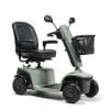 Lichtgroene Scootmobiel EON met zwarte stoel, spiegels en mandje op witte achtergrond