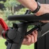Zwarte Flow Fitness Perform S2i spinningfiets met rode hendel en schaalverdeling voor het verstellen van het stuur